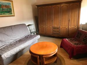 a living room with a couch and a table at Maison Schmidt in Oderen