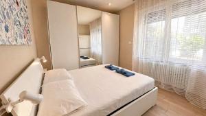 a small room with a bed and a window at BiloVarazze with Terrace in Varazze