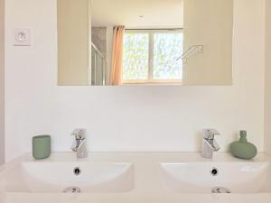 a white bathroom with two sinks and a mirror at Le Sauge, 5 min Gare, Terrasse, Stationnement in Saint-Brieuc +26 photos