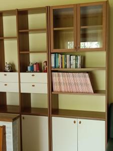 a wooden book shelf with books in it at Casa Sofia in Marina Julia