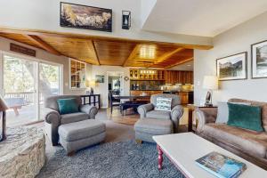 a living room with couches chairs and a table at Bass Lake Lodge in Bass Lake