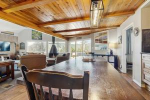 a dining room with a table and a living room at Bass Lake Lodge in Bass Lake