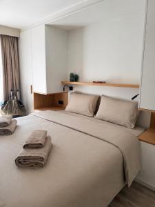 a bedroom with a large bed with towels on it at Knokke Sea, Appartement Vue mer in Knokke-Heist