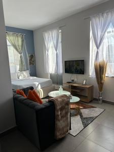 a living room with a couch and a bed at Aegis building in Johannesburg