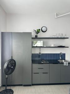 a kitchen with a sink and a clock on the wall at Aegis building in Johannesburg