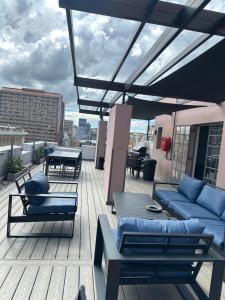 a patio with couches and tables on a roof at Aegis building in Johannesburg