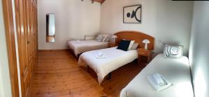 a hotel room with two beds in a room at Escuelas de collía B AT-1537-AS in Arriondas