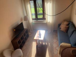 a living room with a blue couch and a coffee table at Escuelas de collía B AT-1537-AS in Arriondas