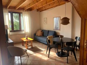 a living room with a blue couch and a table at Escuelas de collía B AT-1537-AS in Arriondas