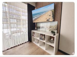 a living room with a flat screen tv on a wall at Studio Palace 217 in Middelkerke