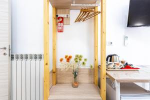 a kitchen with a table and a vase of flowers at Titi Rooms in La Spezia