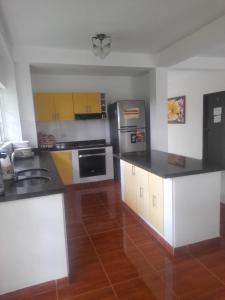 a kitchen with stainless steel appliances and black counter tops at Finca el Amanecer - 30P - Pool in Quimbaya