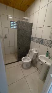 a bathroom with a toilet and a sink at Pousada Ferrari Casa Nostra in Santa Teresa