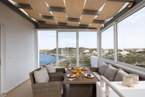 a living room with a couch and a table at Tersanas Seaside Apartment in Tersanas