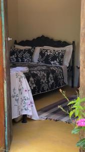 a bedroom with two beds with black and white pillows at Pousada Ferrari Casa Nostra in Santa Teresa