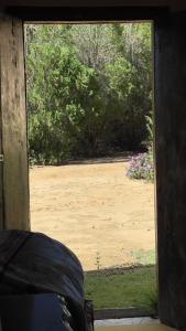 an open door to a yard with a garden at Pousada Ferrari Casa Nostra in Santa Teresa