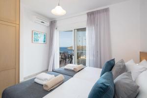 a bedroom with a bed with a view of the ocean at Tersanas Seaside Apartment in Tersanas