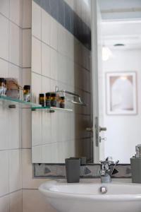 a bathroom with a sink and a mirror at Tersanas Seaside Apartment in Tersanas +32 photos
