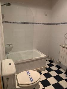 a bathroom with a toilet and a bath tub at Escuelas de collía C AT-1537-AS in Arriondas +15 photos