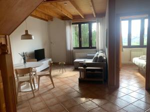 a living room with a table and a couch at Escuelas de collía C AT-1537-AS in Arriondas