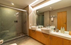 a bathroom with two sinks and a shower at Casa Reforma by Kukun in Mexico City