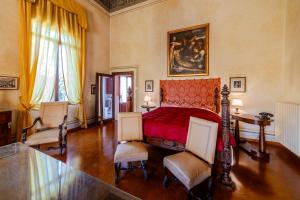 a bedroom with a bed and a table and chairs at Castello di Roncade in Roncade