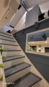 a staircase in a house with a mirror at Dans un parc privatif arboré in Réau