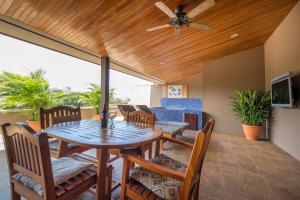 a dining room with a table and chairs at Monaco Condominiums in Jacó