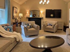 a living room with a couch and chairs and a tv at Property 472 - Kylemore in Kylemore
