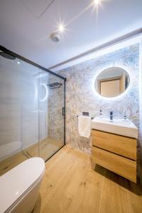 a bathroom with a toilet and a sink and a shower at Apartamentos Sibarys in Nerja +88 photos