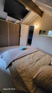 a bedroom with a large bed in a room at Dans un parc privatif arboré in Réau