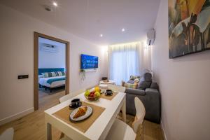 a living room with a table and a couch at Apartamentos Sibarys in Nerja