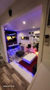 a view of a living room with a white table at Dans un parc privatif arboré in Réau