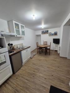 a kitchen and dining room with a table in it at Studio Les Sapins in Chapois