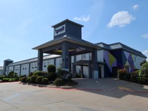 a hotel building with a sign on top of it at Spark by Hilton Terrell in Terrell