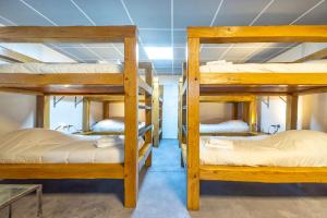 a group of bunk beds in a room at Le Xilotik Gîte in Espelette