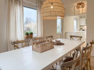 a dining room with a white table and chairs at Cozy Home in Timmendorfer Strand