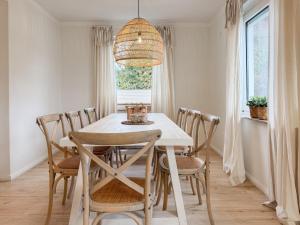 a dining room with a white table and chairs at Cozy Home in Timmendorfer Strand