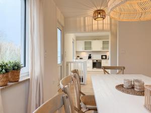 a kitchen and dining room with a table and chairs at Cozy Home in Timmendorfer Strand