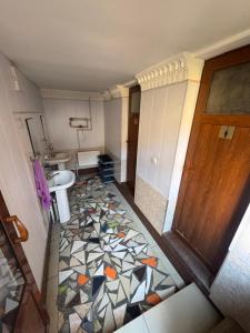 a bathroom with a sink and a mosaic floor at Hotel & Hostel Siyob Samarkand in Samarkand