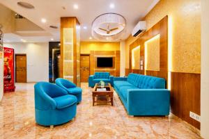a lobby with blue couches and a table at Hotel Golden Oasis - 5 Minute Walk from New Delhi Railway Station in New Delhi