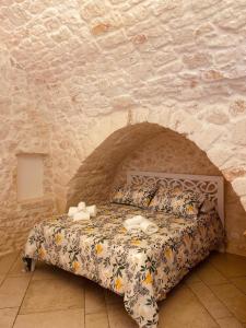 a bedroom with a bed in a stone wall at SPA homes by Pcb in Ostuni +38 photos