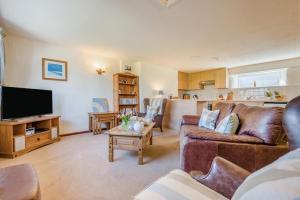 a living room with a couch and a tv at 1 Bed in Padstow oc-p00554 in Saint Merryn