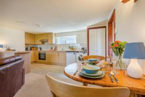 a kitchen and dining room with a wooden table and chairs at 1 Bed in Padstow oc-p00554 in Saint Merryn