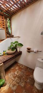 a bathroom with a toilet and a plant on a table at Villas Boutique Antheia in La Orilla