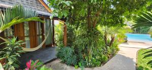 a house with a porch with trees and plants at Villas Boutique Antheia in La Orilla