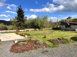 a backyard with a garden with a tree in it at Le Milpa LXXXVIII in Brouvelieures +9 photos