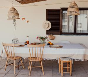 a kitchen with a table and two chairs at Casa Manjerico in Loulé