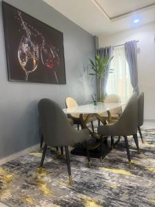 a dining room with a table and chairs at Max Heights, 2 Captivating Bedrooms in Ikeja