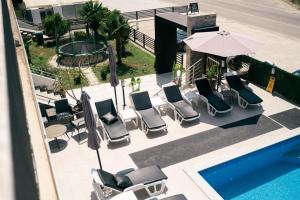 an overhead view of chairs and an umbrella next to a pool at Capital Rooms in Ulcinj